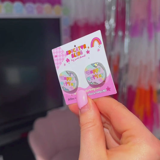 Short video of teacher holding Happy FriYAY rainbow glitter acrylic stud earrings sparkling in the light – handmade teacher accessory by Educator Bling.