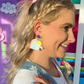 Total Book Worm book-loving teacher earrings styled with pastel books and stationery