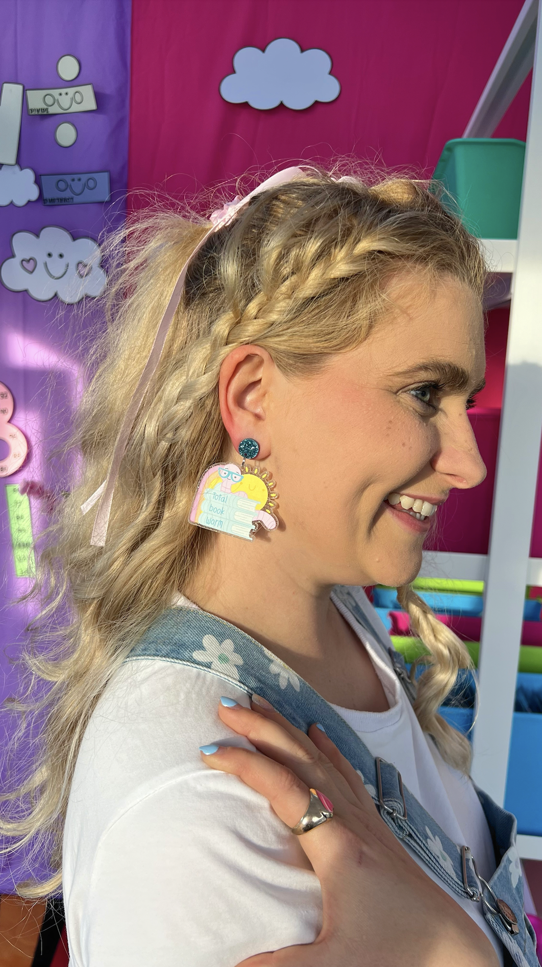 Total Book Worm book-loving teacher earrings styled with pastel books and stationery