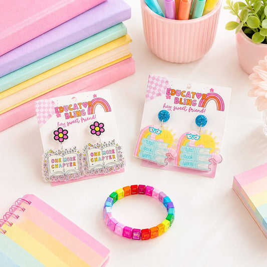 Educator Bling Book Week Teacher Bundle – bookworm teacher earrings and rainbow crystal bracelet styled on a pastel desk