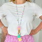 Primary school teacher wearing pastel beaded lanyard in classroom setting