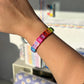 Rainbow crystal tile stretch bracelet worn on a teacher's wrist – Educator Bling