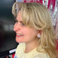 Teacher wearing Happy FriYAY rainbow sparkle acrylic stud earrings in classroom – Educator Bling handmade accessory.